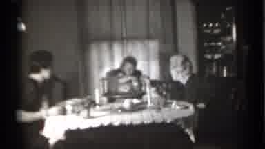 New York (1939): Family Sitting At Table With Child Handing M Something