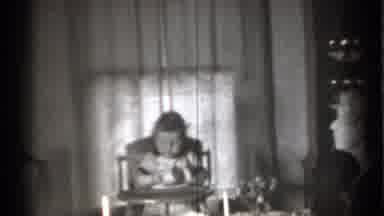 New York (1939): Baby Sits In High Chair Looking At Small White Cup