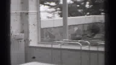 San Francisco California (1944): Woman Wearing Red Hat Walks Through Wooden Do