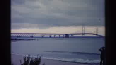 Michigan USA (1960): Man Enjoys Beautiful Sea Side And Huge Bridge With Binocular
