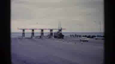 Michigan USA (1960): Car Drives To Entrance Gates Of Ferry Castle Rock Is Written