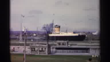 Michigan USA-1960: Black Ford Ship And Red Freighter Docked At Canal Lock