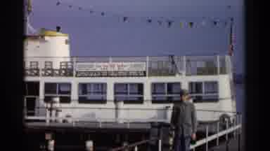 Michigan USA (1960): Man Standing In Father Of Boat Docked In Other