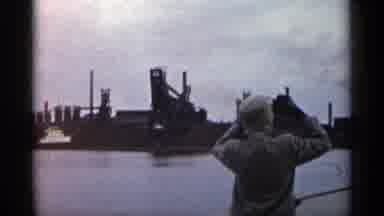 Michigan USA (1960): Woman Filming Red And Black Boat Docked At Shipyard