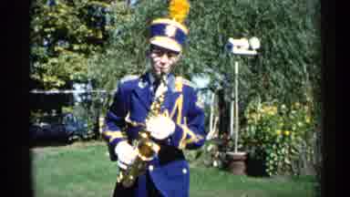 Michigan USA (1960): Water Gently Flows Over Ledge And Boy Plays A Instrument