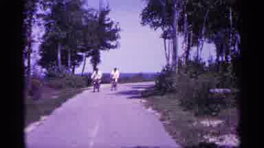 Michigan USA (1960): Two People Ride Bike Down Rod And One Person Starts Swerving