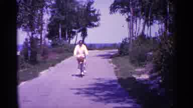 Michigan USA (1960): Person Riding Bike Towards Comer