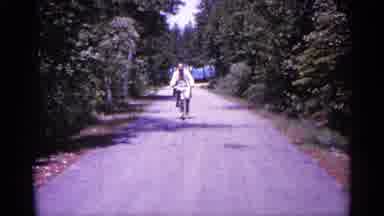 Michigan USA (1960): Man Riding His Bike And Waving