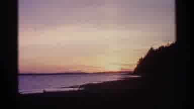 Michigan USA (1960): Gold Sun Setting Behind Mountain And Ocean On Cleo Day