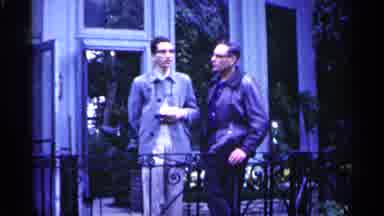 Minnesota USA (1961): Two Men Talk Behind Riling Caricature Les Behind Glass On H
