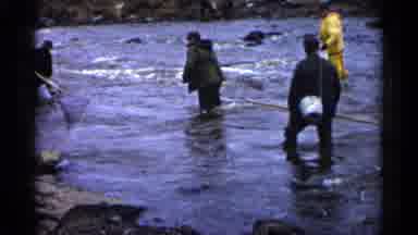 Minnesota USA (1961): People In Jackets Fishing With Nets In River Gins Wind One