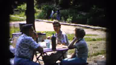 Minnesota USA (1961): People Sitting At Small Outdo Other Table Under Shade Tree