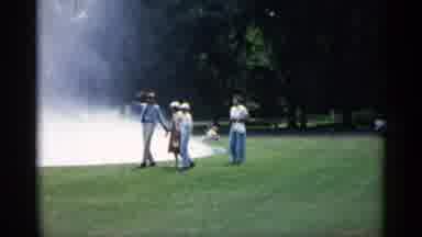 Minnesota USA (1961): Four People Fountain Water Park Grass Car Daytime Outdo