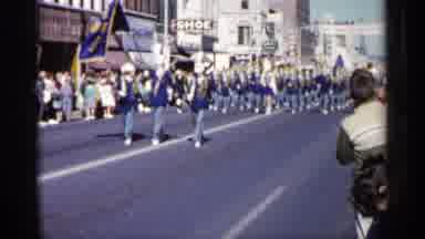 Minnesota USA (1961): People Wearing Uniforms Marching Down Street In Town
