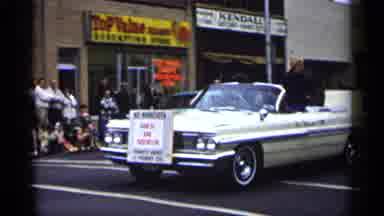 Minnesota USA (1961): Woman Waving While Sitting In Moving Car Driving Slowly