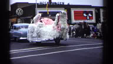Minnesota USA (1961): Flo Being Pulled Down Street Rod With Car Pride Older Car
