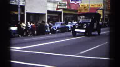 Minnesota USA (1961): Old Fashioned Car Driving Through City Street Long Pride