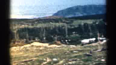 Colorado USA (1963): Adults Walk While Children Dig In Sn Lot One Mountain Ridge