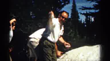 Colorado USA (1963): Man Throwing Snow Father On Pile On Ground At His Family