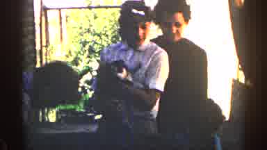 Colorado USA (1963): Child And Woman Holds Wiggly Puppy Barefoot Setting It Down