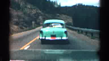 Colorado USA (1963): Vehicle Drives Down Mountain Highway Behind Nineteen Fifties