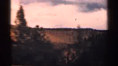Colorado USA (1963): Cars Driving On Windy Rod With Views Of Trees And Mountains
