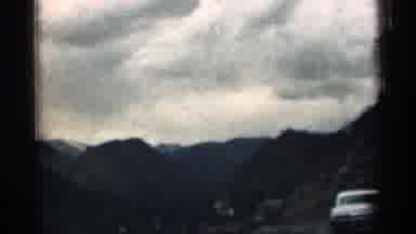 Colorado USA (1963): Set Of Cars Riding In Hills And Huge Advertisement Bird Over