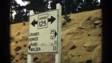 Colorado USA (1963): Barefoot Continuing Air Journey Travelers Look At Rod Sign