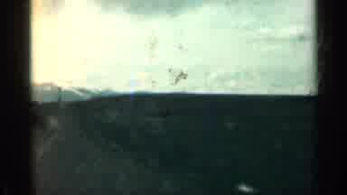 Colorado USA (1963): Passing Mountains And White Headstone On Sunny Day