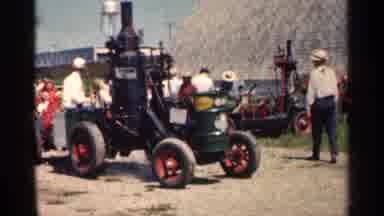 Montgomery Minnesota (1963): People Riding Round In Very Old Looking Car With Wing