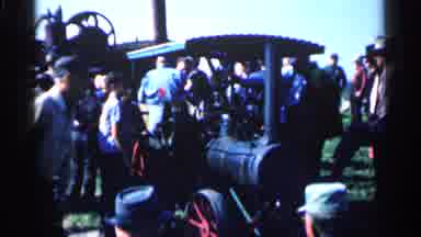 Montgomery Minnesota (1963): Dressed Adults Gathered Around A Car Fixing