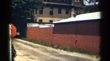 Texas USA (1963): Brick Wall In Front Of A Parking Lot