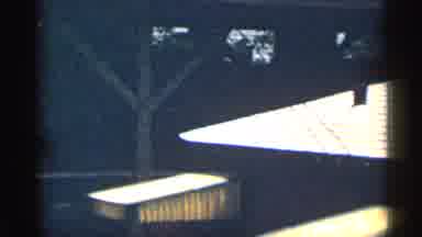 Texas USA (1963): Woman Wearing Brown Dress Open Do Other Of Blue Car On Sunny Day