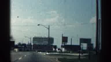 Texas USA (1963): Driving Long And Passing Big Tall Sign Advertising Something Who
