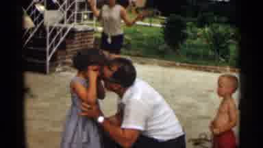Texas USA (1963): Man Wearing White Shirt Comforters Girl Wearing Blue Dress On