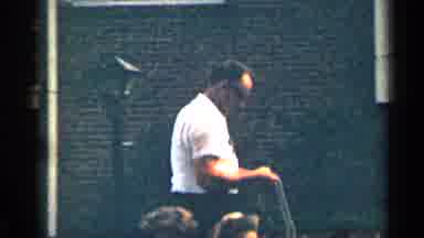 Texas USA (1963): Man Wearing White Shirt Walks Away Father On Brown Dogs On Sunny