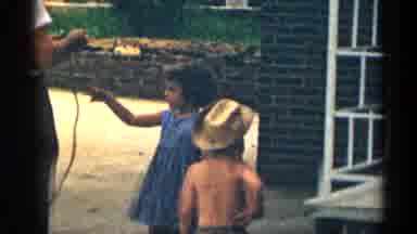 Texas USA (1963): Father Is Entertaining Other Helping His Children With Toy Whip