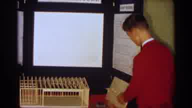 Texas USA (1963): Person Wearing Red Sweater Sets Up Architecture Display Objects