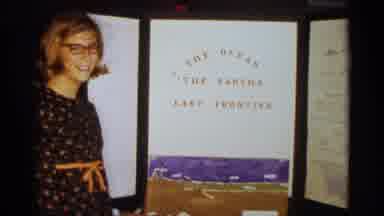 Texas USA (1963): Girl Standing Next To Her Project S She Smiles And Looks Back At