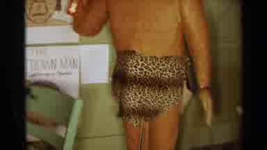 Texas USA (1963): Cavemen Statue In Tiger Print Surrounded By Rt Of Cavemen By