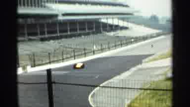 Indianapolis USA (1964): Yellow Recce Speeding Round Empty Racetrack On Sunny Day
