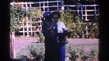 New York City (1964): Women In Sunglasses In Garden Standing By Statue Among