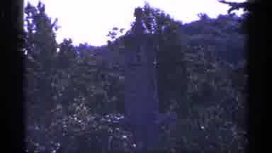 Pennsylvania (1964): Person Wearing Blue Ants Looks At Grey Statue On Sunny Day