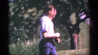 Duluth Minnesota (1965): Man Wearing Glasses Walks By Comer And Sign Ares Sunrise