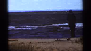Duluth Minnesota (1965): A Dressed Man Dressed Walks On A Beach Alone