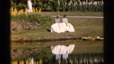 Florida USA (1966): Two Women Sitting On Riverbank Wave At Comer