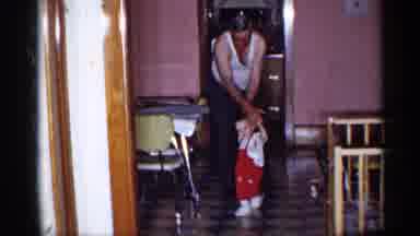 New York (1955): Grandpa Holding Grandson Helping Him Walk Down Kitchen