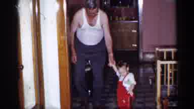 New York (1955): Grandpa Holding Grandson Helping Him Walk Down Kitchen