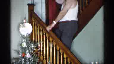 New York (1955): Man Wearing Grey Ants Climbs Brown Wooden Staircase Next To