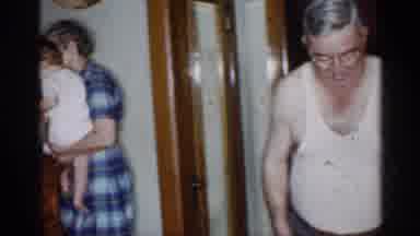 New York-1955: Woman In Blue Plaid Dress Carries Baby Up Stairs, Child In Highchair
